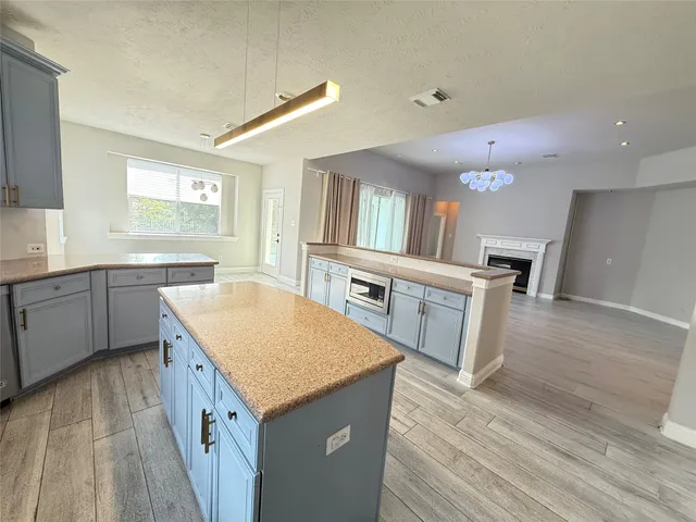 a kitchen with a sink and wooden floor