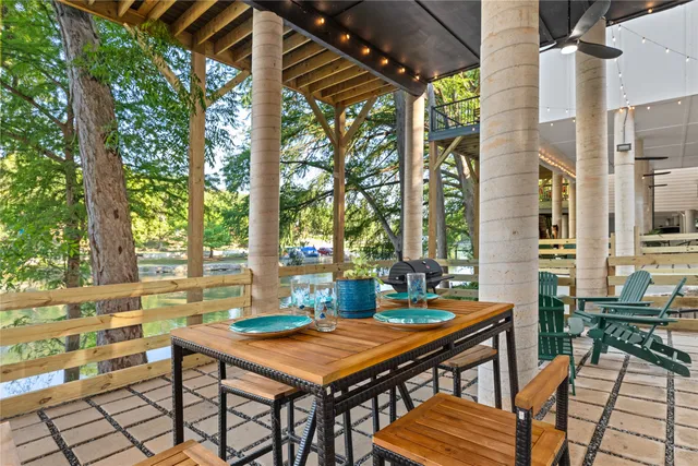 a backyard of a house with table and chairs