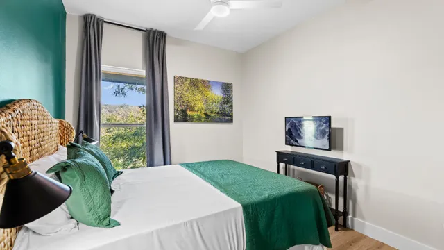 a bedroom with a bed and a television