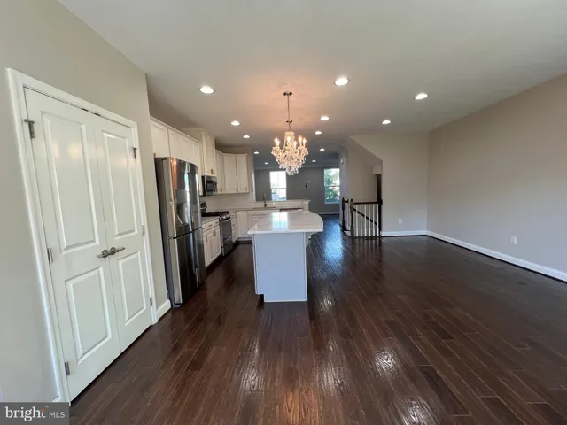 a view of kitchen with refrigerator microwave and wooden floor