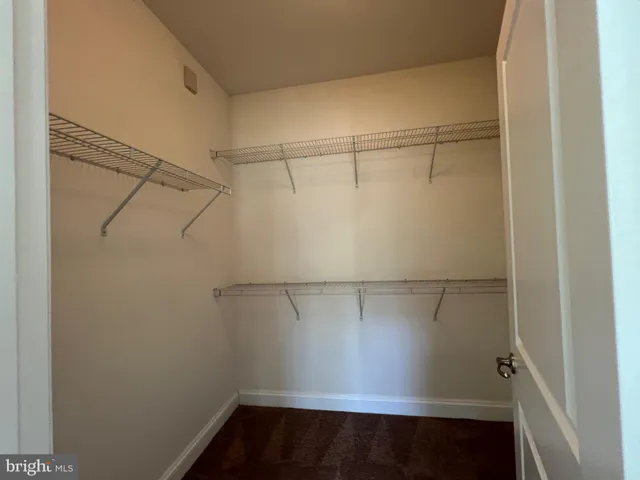 a bathroom with a granite countertop sink a mirror and a bathtub