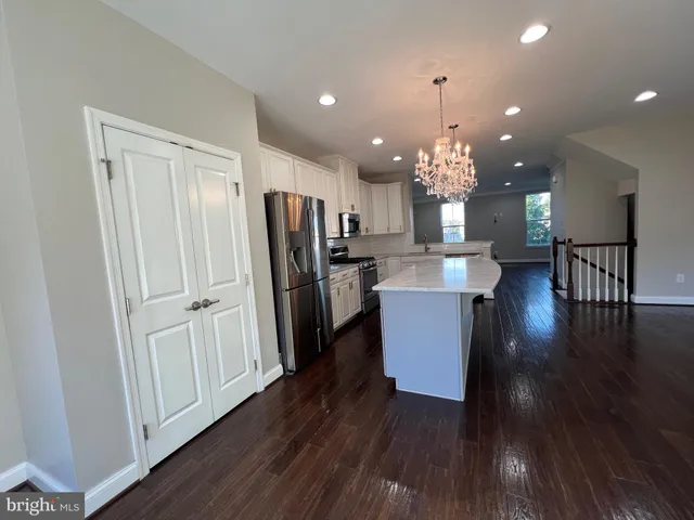a view of kitchen with refrigerator microwave and wooden floor