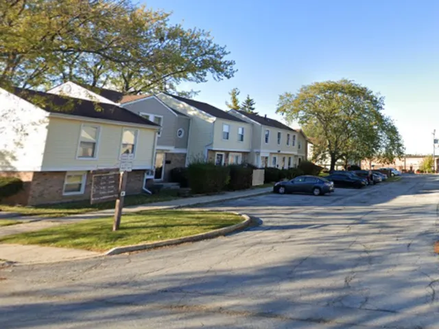 a view of a swimming pool with a house in the background