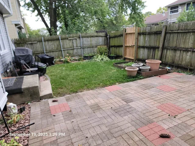 a backyard of a house with table and chairs