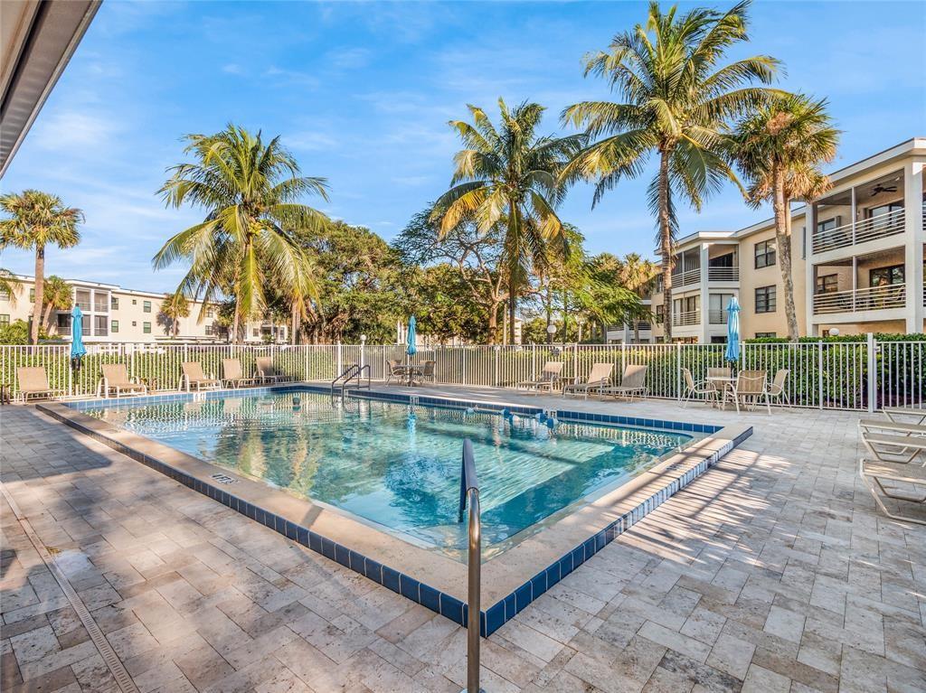 300 North Hwy A1A, Unit 103E Jupiter, FL 33477 - Photo 11 of 12 a view of swimming pool with a table and chairs