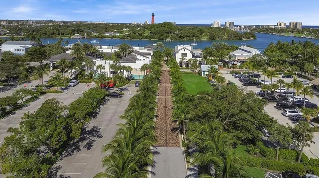an aerial view of residential house with outdoor space and trees all around