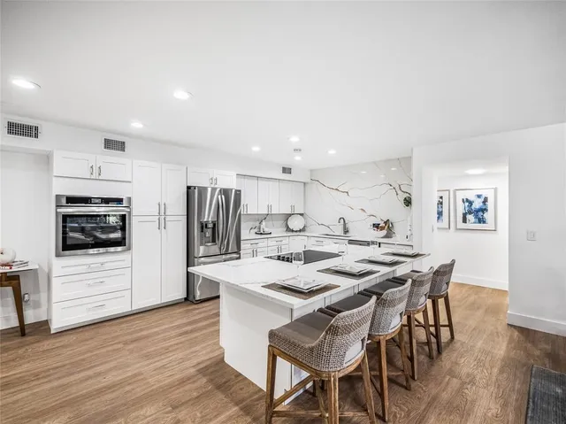 a view of kitchen with cabinets table and chairs