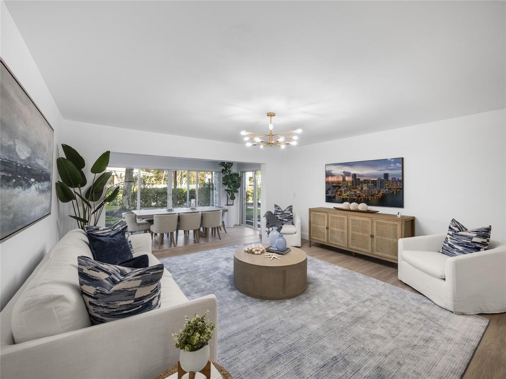 300 North Hwy A1A, Unit 103E Jupiter, FL 33477 - Photo 4 of 12 a living room with furniture and a large window