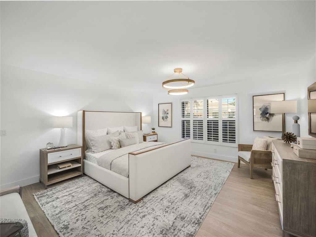 300 North Hwy A1A, Unit 103E Jupiter, FL 33477 - Photo 5 of 12 a bedroom with a bed and a large window