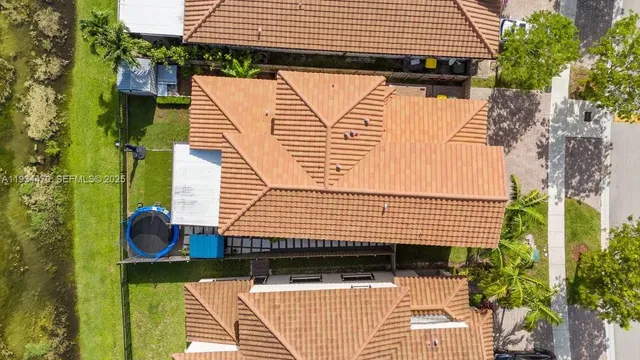 an aerial view of multiple houses with yard