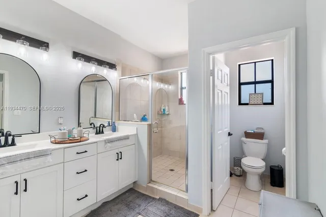 a bedroom with a bed lamp and a window