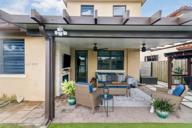 a living room with patio furniture and a floor to ceiling window