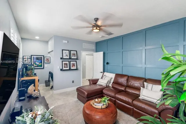 a living room with furniture and a bookshelf