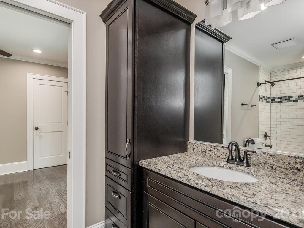 5923 Sharon View Road Charlotte, NC 28226 - Photo 14 of 44 a bathroom with a granite countertop sink and a mirror