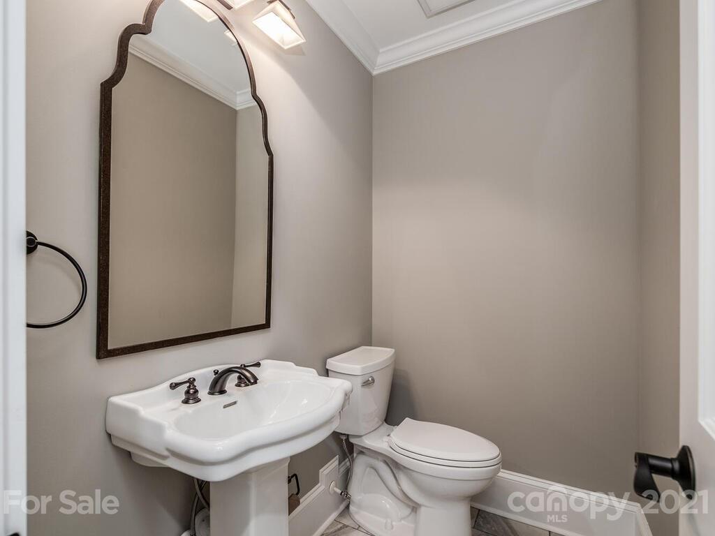 5923 Sharon View Road Charlotte, NC 28226 - Photo 16 of 44 a bathroom with a toilet sink and mirror