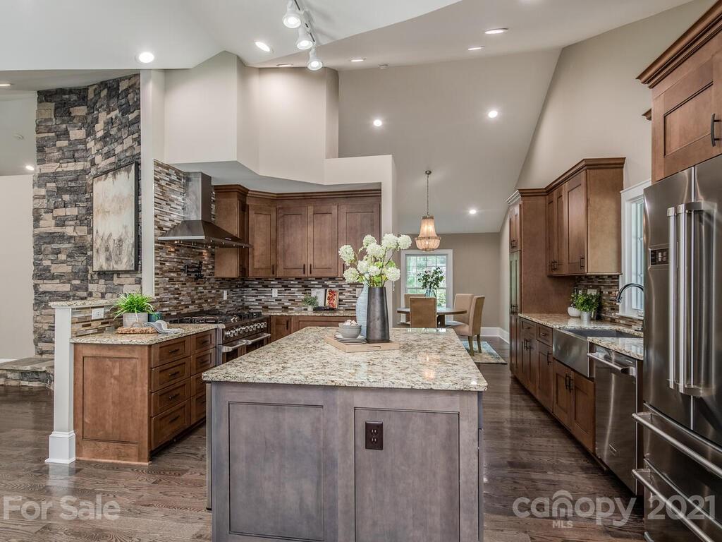 5923 Sharon View Road Charlotte, NC 28226 - Photo 20 of 44 a kitchen with stainless steel appliances granite countertop a sink stove and refrigerator