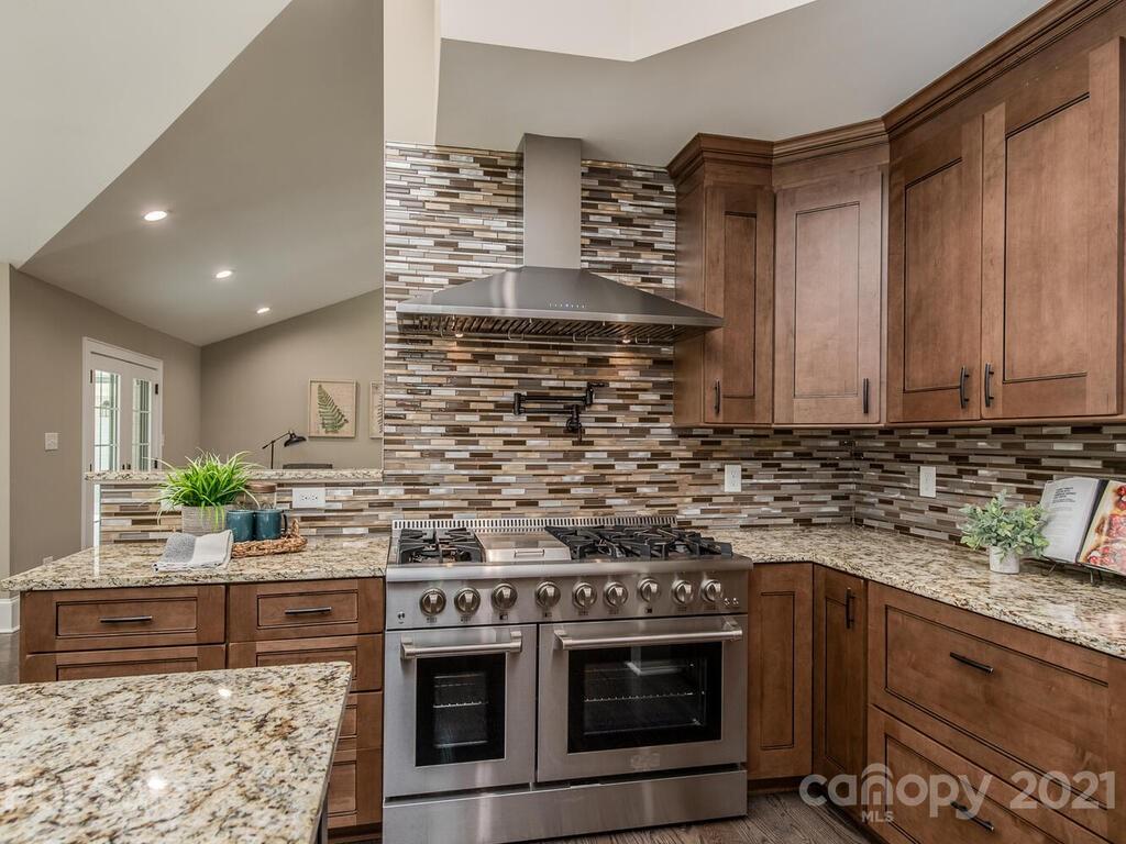 5923 Sharon View Road Charlotte, NC 28226 - Photo 21 of 44 a kitchen with stainless steel appliances granite countertop a stove a sink and a microwave