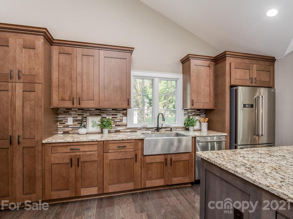 5923 Sharon View Road Charlotte, NC 28226 - Photo 22 of 44 a kitchen with stainless steel appliances granite countertop a sink stove and refrigerator