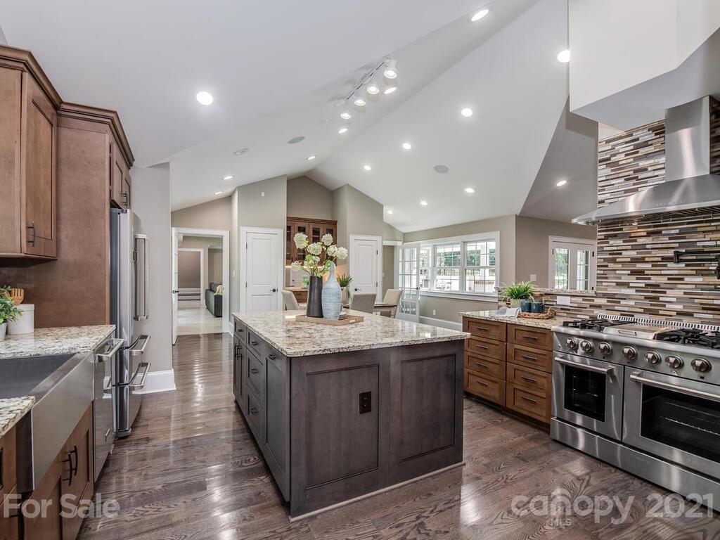 5923 Sharon View Road Charlotte, NC 28226 - Photo 23 of 44 a kitchen with stainless steel appliances granite countertop a stove and a sink