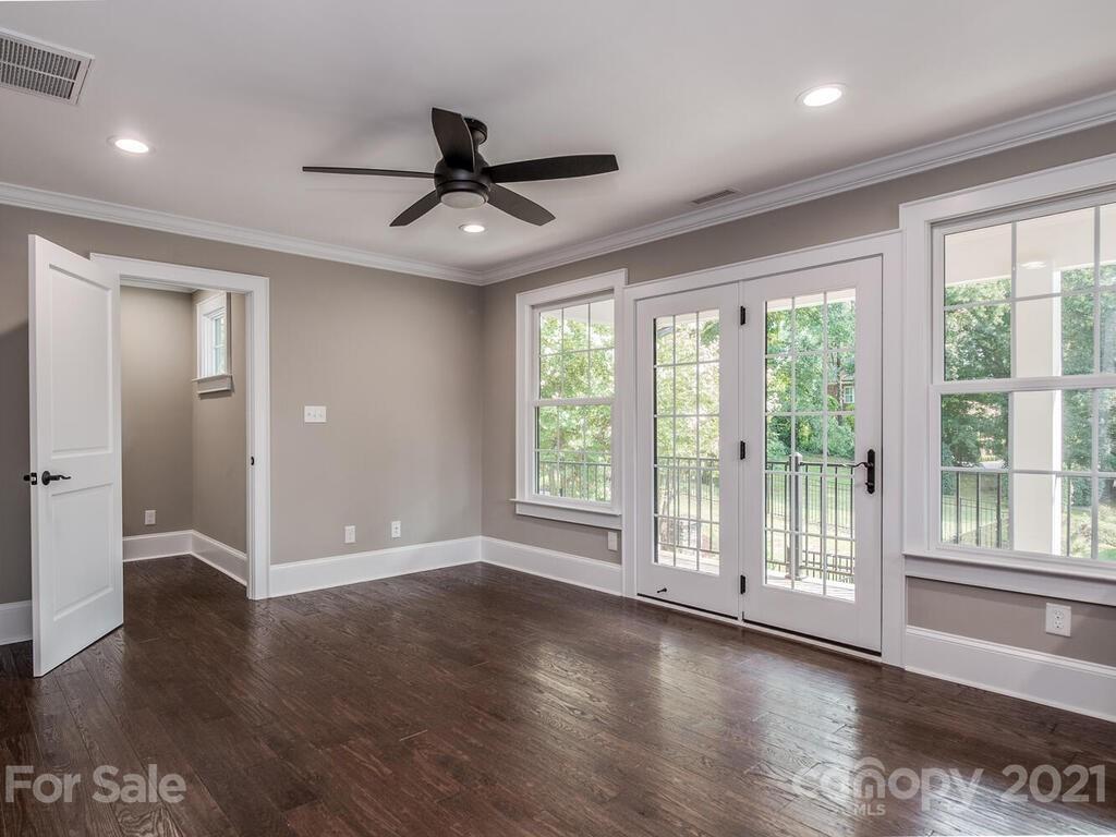 5923 Sharon View Road Charlotte, NC 28226 - Photo 27 of 44 a view of an empty room with wooden floor and a window