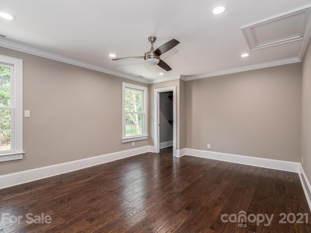 5923 Sharon View Road Charlotte, NC 28226 - Photo 30 of 44 a view of an empty room with wooden floor and a window