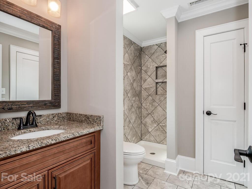 5923 Sharon View Road Charlotte, NC 28226 - Photo 31 of 44 a bathroom with a granite countertop sink toilet and shower
