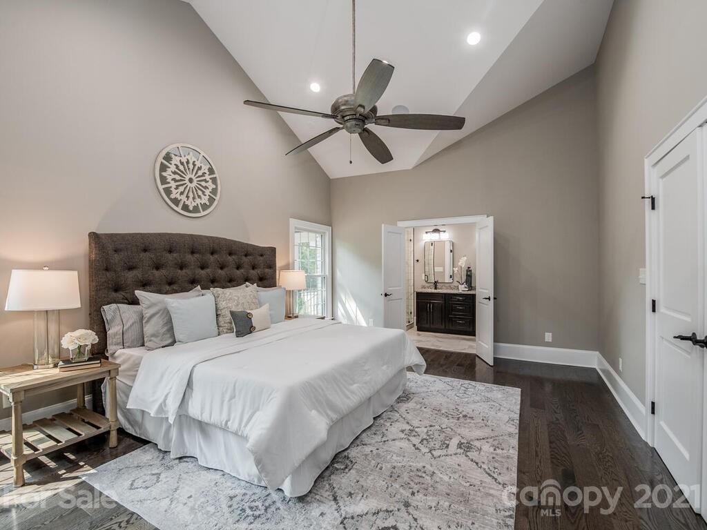 5923 Sharon View Road Charlotte, NC 28226 - Photo 7 of 44 a bedroom with a bed and a lamp on a dresser