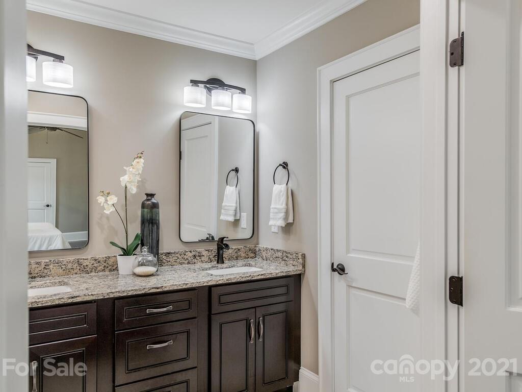 5923 Sharon View Road Charlotte, NC 28226 - Photo 9 of 44 a bathroom with a granite countertop sink vanity and mirror
