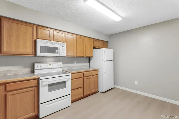 a kitchen with a stove microwave and sink