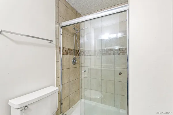 a bathroom with a shower and a toilet