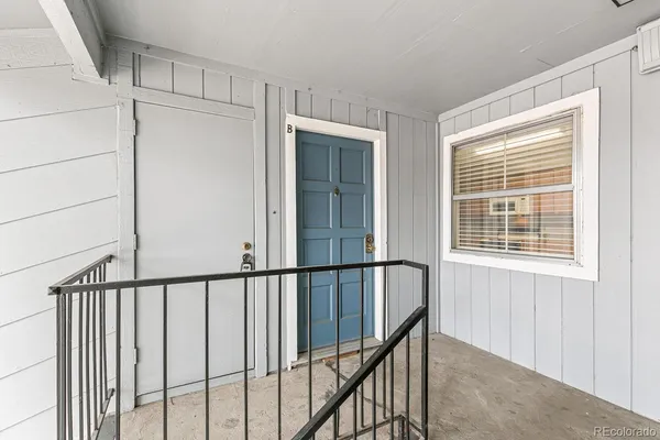 a view of staircase with railing and a window