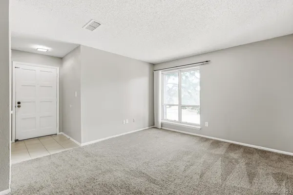 a view of an empty room with a window
