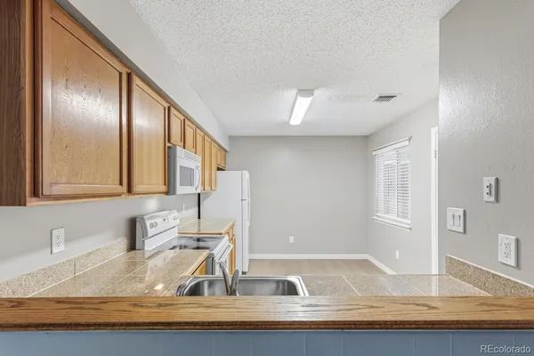 a kitchen with granite countertop a sink and a window