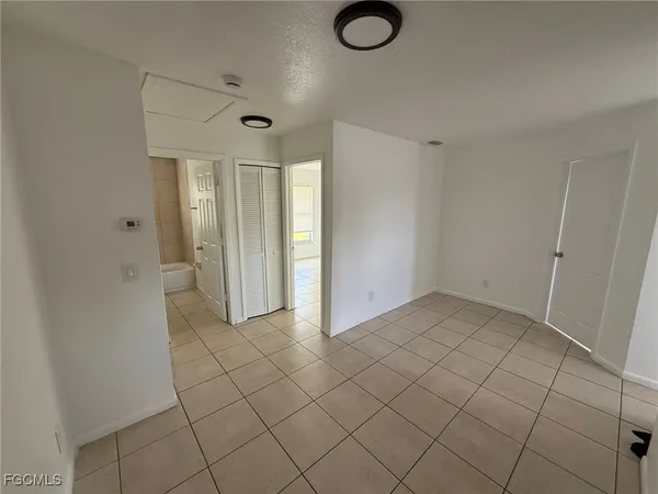 an empty room with windows and closet