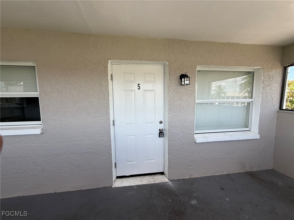11431 Char Ann Drive, Unit 5 Fort Myers, FL 33908 - Photo 13 of 14 an empty room with windows and closet