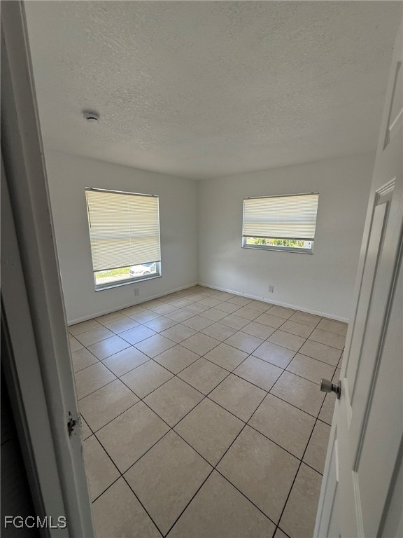 11431 Char Ann Drive, Unit 5 Fort Myers, FL 33908 - Photo 5 of 14 a view of an empty room and window
