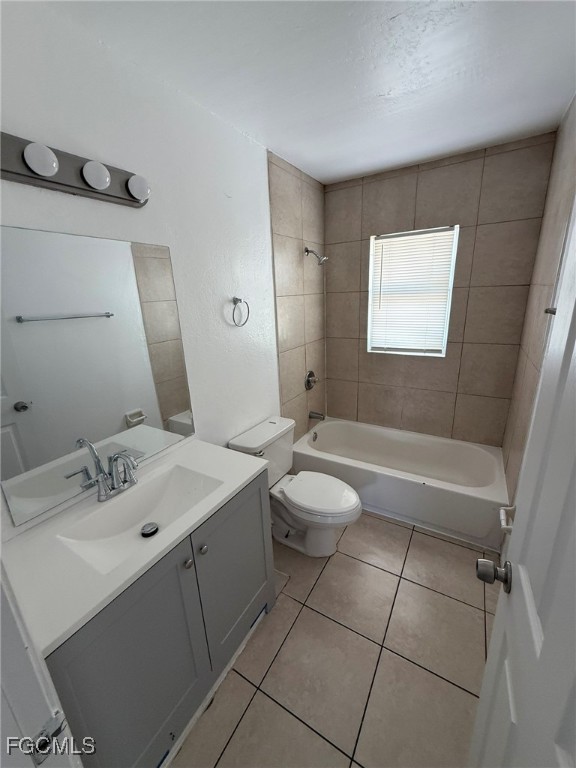 11431 Char Ann Drive, Unit 5 Fort Myers, FL 33908 - Photo 8 of 14 a bathroom with a sink a toilet and tub
