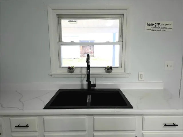 a kitchen with a sink and a window