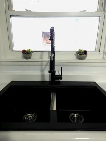 a kitchen with stainless steel appliances a stove a microwave and white cabinets