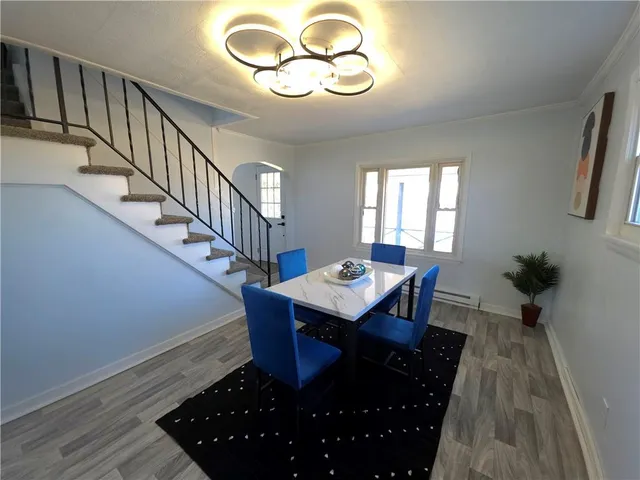 a view of a dining room with furniture and wooden floor