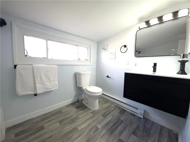 a bathroom with a toilet sink and mirror