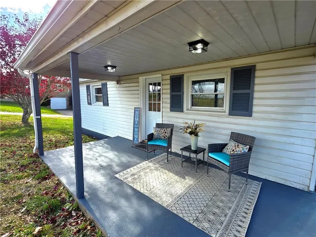 a view of a house with backyard and sitting area