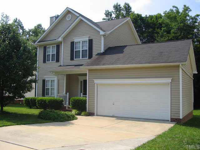 a view of a house with a yard and garage