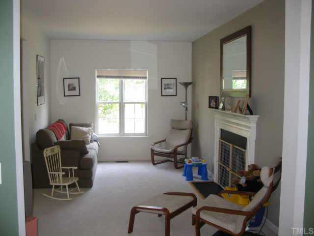 3336 Forest Mill Circle Raleigh, NC 27616 - Photo 4 of 10 a living room with furniture and a fireplace