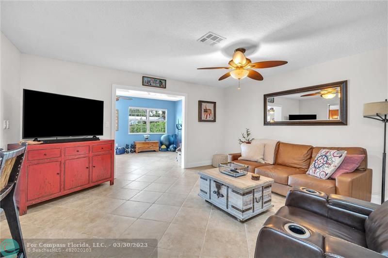 5206 Cleveland Street Hollywood, FL 33021 - Photo 11 of 49 a living room with furniture and a flat screen tv