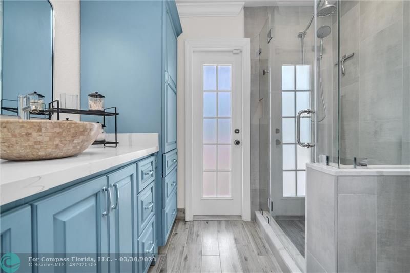 5206 Cleveland Street Hollywood, FL 33021 - Photo 17 of 49 a bathroom with a granite countertop sink a mirror and shower