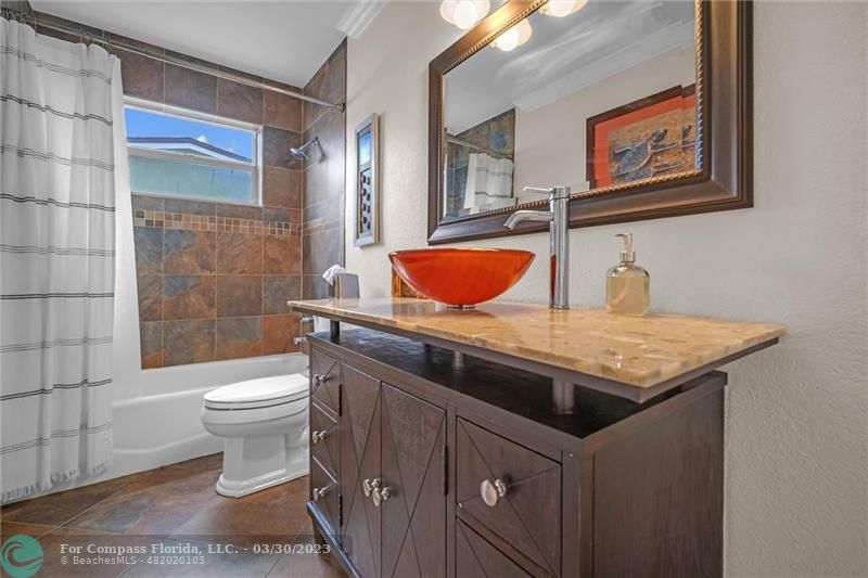 5206 Cleveland Street Hollywood, FL 33021 - Photo 21 of 49 a bathroom with a granite countertop toilet sink and mirror