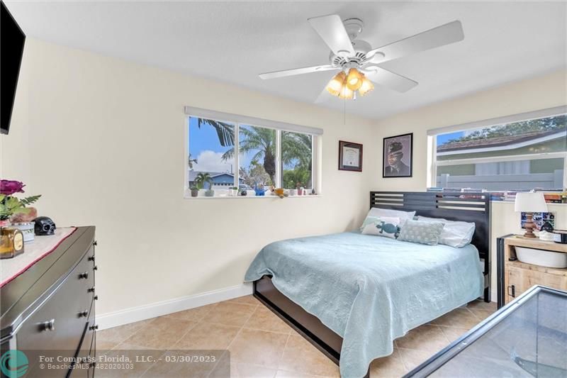 5206 Cleveland Street Hollywood, FL 33021 - Photo 22 of 49 a bedroom with a bed and a chandelier