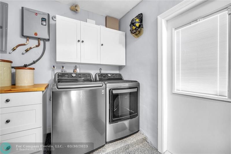 5206 Cleveland Street Hollywood, FL 33021 - Photo 23 of 49 a kitchen with a stove and a refrigerator