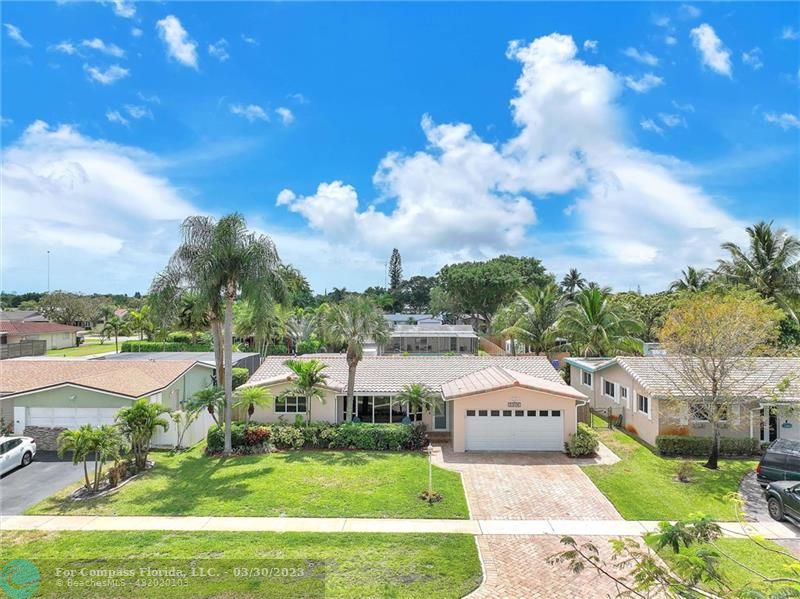 5206 Cleveland Street Hollywood, FL 33021 - Photo 29 of 49 a aerial view of a house with a big yard and large trees
